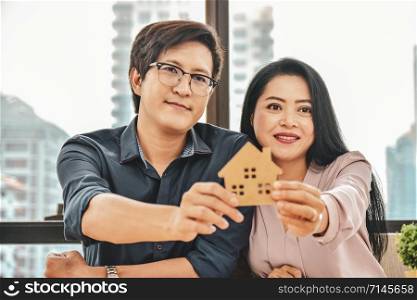 Husband and wife are buying a home,Close up Hand holding home model