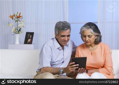 Husband and wife looking at a photo
