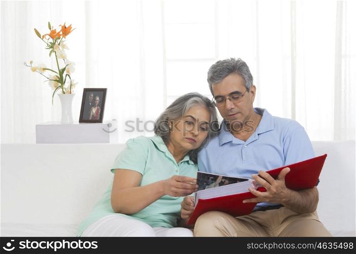 Husband and wife looking at a wedding album