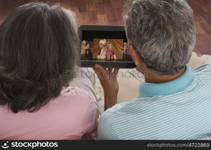 Husband and wife looking at picture of their children