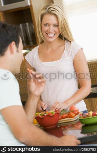 Husband And Wife Preparing Dinner