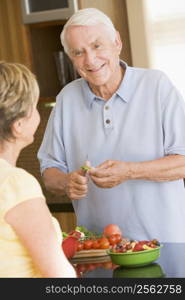 Husband And Wife Preparing Vegetables