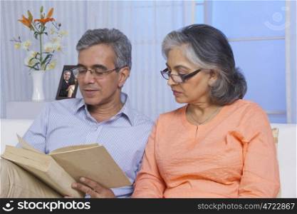Husband and wife reading a book