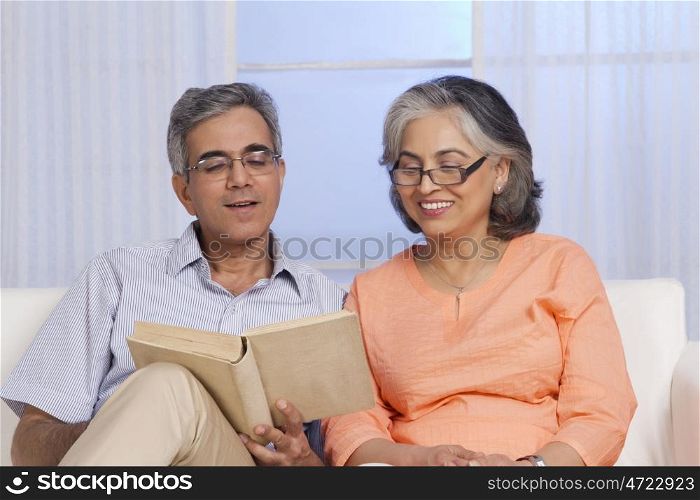 Husband and wife reading a book