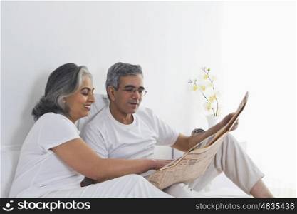 Husband and wife reading the newspaper