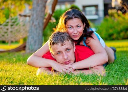 husband and wife relaxing on the green lawn