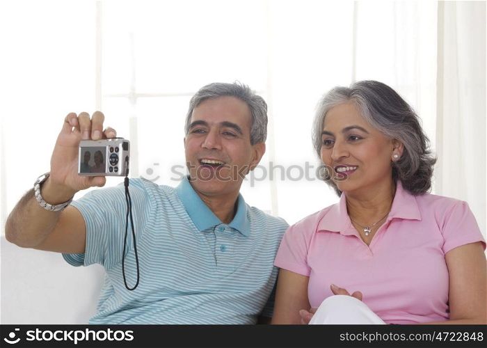 Husband and wife taking a photograph