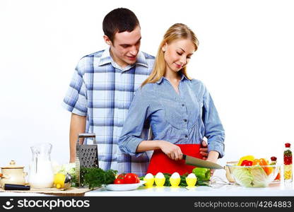 Husband and wife together coooking at home