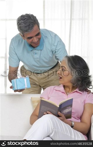 Husband giving a gift to his wife