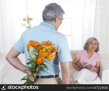 Husband giving flowers to his wife