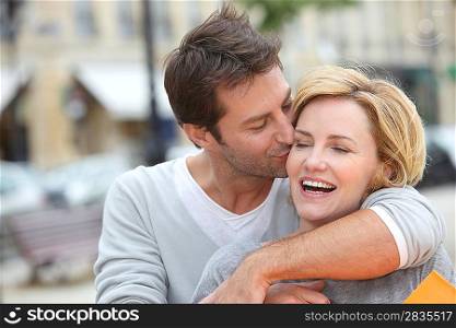 Husband kissing wife