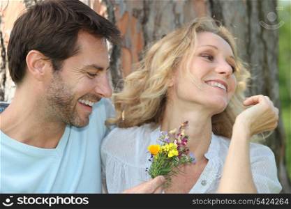 Husband offering wife flowers