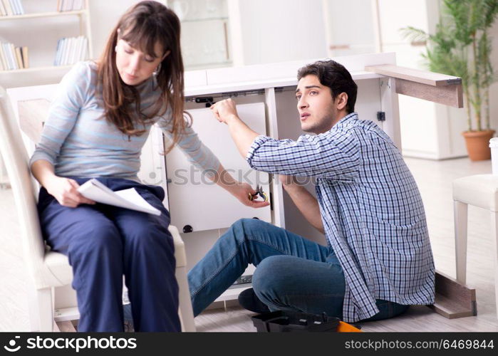 Husband repairing broken table at home