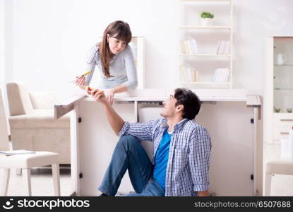 Husband repairing broken table at home