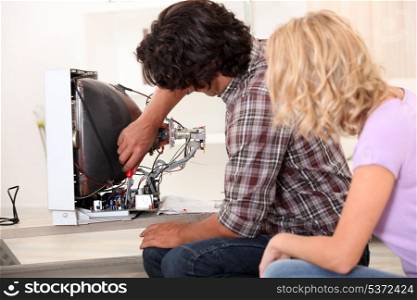 Husband repairing television set