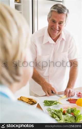 Husband Talking To Wife While Preparing meal,mealtime