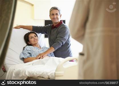 Husband Visiting Wife In Hospital And Talking To Doctor