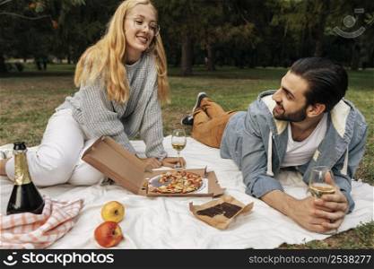 husband wife having picnic together