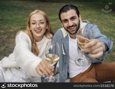 husband wife having picnic together outside