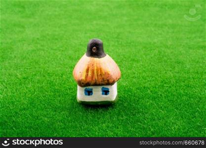 Hut model on green grass