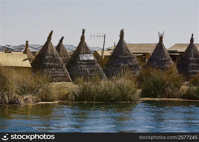 Huts in a village at the waterfront, Lake Titicaca, Uros Floating Islands, Puno, Peru
