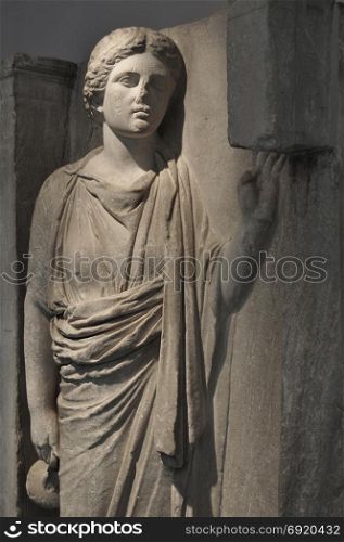 Hydriaphoros statue of woman carrying hydria pottery with water in religious procession. Ancient grave relief from Keramikos cemetery circa 350 BC, Athens Greece.