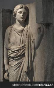 Hydriaphoros statue of woman carrying hydria pottery with water in religious procession. Ancient grave relief from Keramikos cemetery circa 350 BC, Athens Greece.