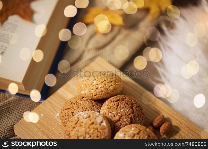 hygge, food and baking concept - oatmeal cookies on wooden board at home. oatmeal cookies on wooden board at home