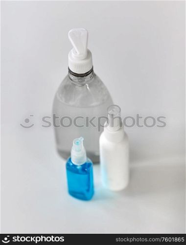 hygiene and disinfection concept - close up of different hand sanitizers on table. close up of different hand sanitizers on table