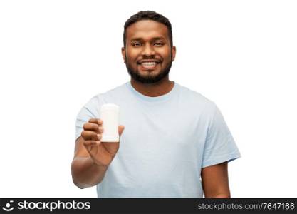 hygiene, grooming and people concept - happy smiling african american man with antiperspirant deodorant over white background. african american man with antiperspirant deodorant