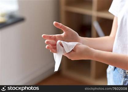hygiene, health care and disinfection concept - close up of woman cleaning hands with antiseptic wet wipe. woman cleaning hands with antiseptic wet wipe