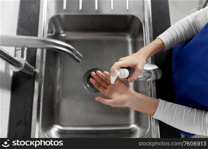 hygiene, health care and safety concept - close up of female doctor or nurse washing hands with liquid soap at hospital. doctor or nurse washing hands with liquid soap