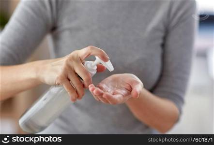 hygiene, health care and safety concept - close up of woman applying antibacterial hand sanitizer. close up of woman applying hand sanitizer