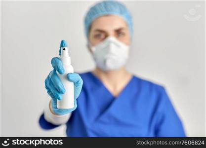 hygiene, healthcare and safety concept - close up of doctor or nurse wearing face protective medical mask or respirator for protection from virus disease with hand sanitizer. close up of doctor or nurse with hand sanitizer