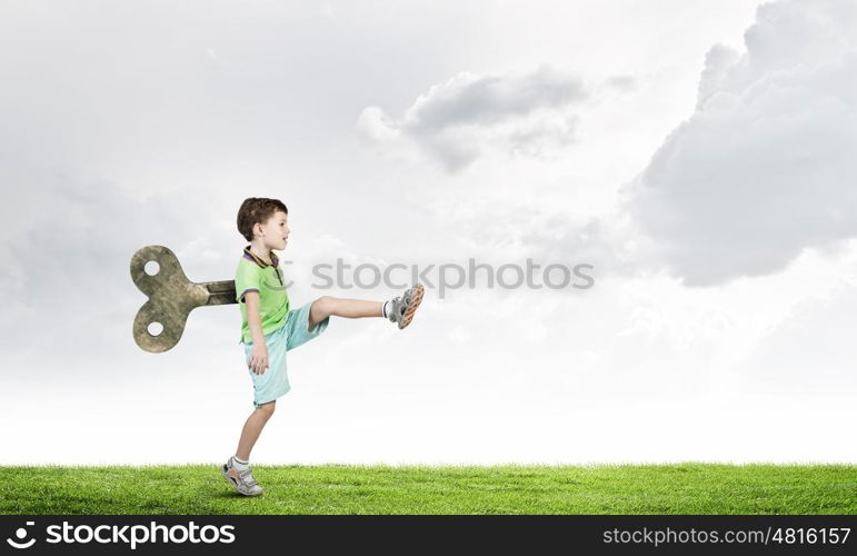 Hyperactive happy child. Little cute active boy with key on back