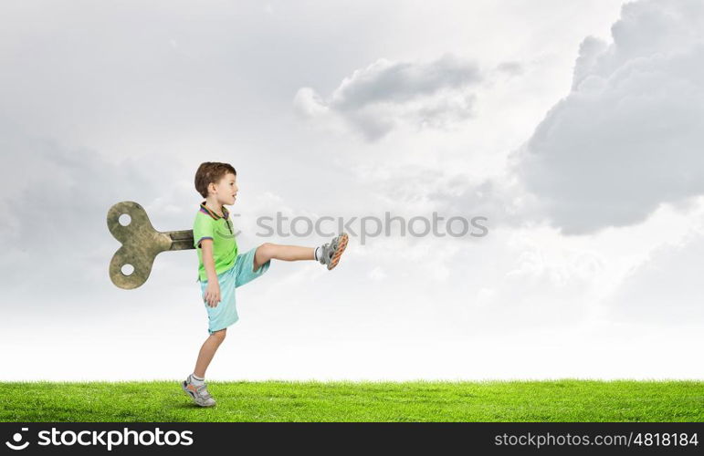 Hyperactive happy child. Little cute active boy with key on back