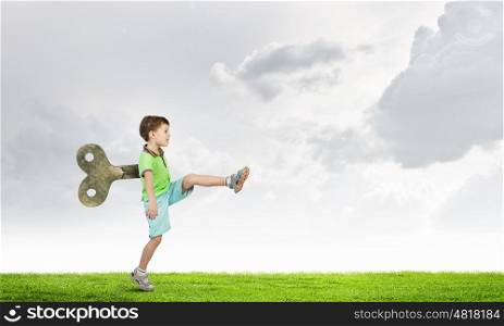 Hyperactive happy child. Little cute active boy with key on back