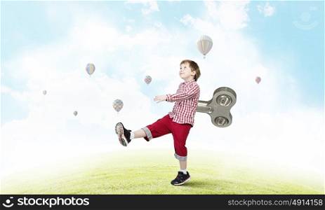 Hyperactive happy child. Little cute active boy with key on back