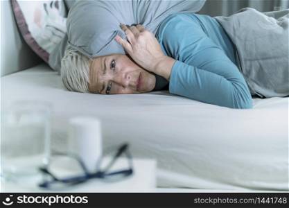 Hyperacusis Disorder. Mature Woman Suffering From Hyperacusis, Fear of Sounds Holding Pillow Over Her Head