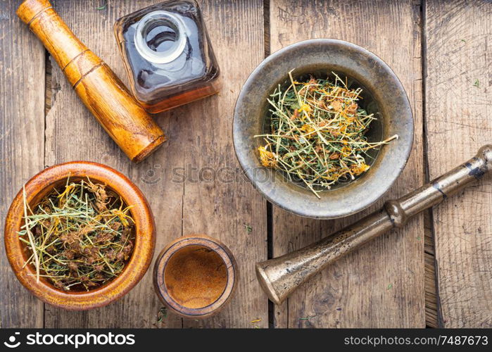 Hypericum perforatum.Healing herbs on wooden table.Medicinal plant. Dry yellow flowers Hypericum