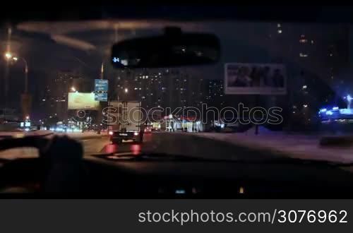Hyperlapse of night driving from car in winter. City, blurred motion, fast driving. View from inside of automobile.
