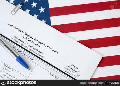 I-485 Application to register permanent residence or adjust status blank form lies on United States flag with blue pen from Department of Homeland Security close up. I-485 Application to register permanent residence or adjust status blank form lies on United States flag with blue pen from Department of Homeland Security