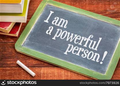 I am a powerful person - positive affirmation words on a slate blackboard with chalk and books