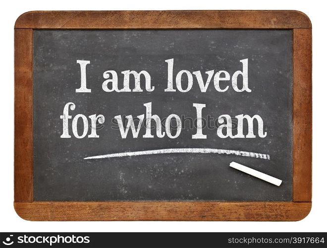 I am loved for who I am - positive affirmation words on a vintage slate blackboard