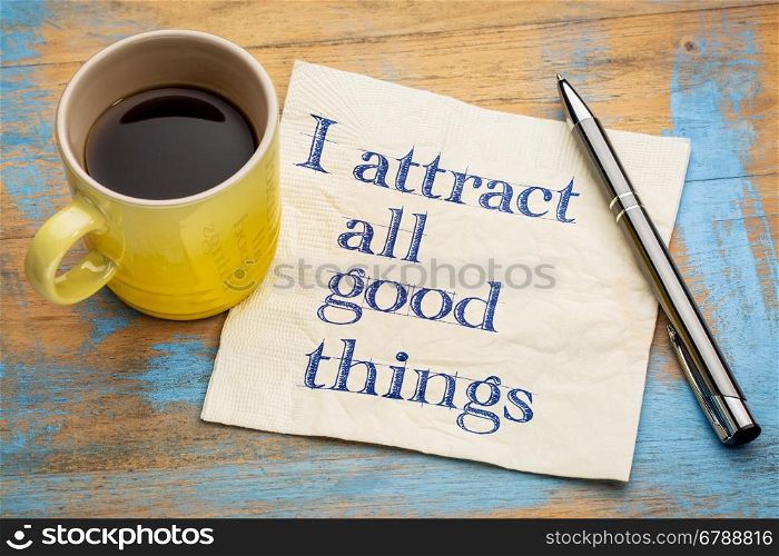I attract all good things - positive affirmation words - handwriting on a napkin with a cup of coffee