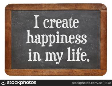 I create happiness in my life - positive affirmation words on a vintage slate blackboard
