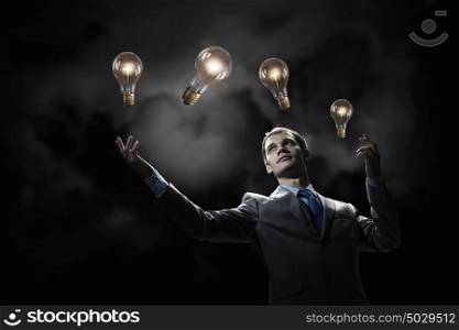 I have an idea. Young businessman pointing with finger at glowing light bulb