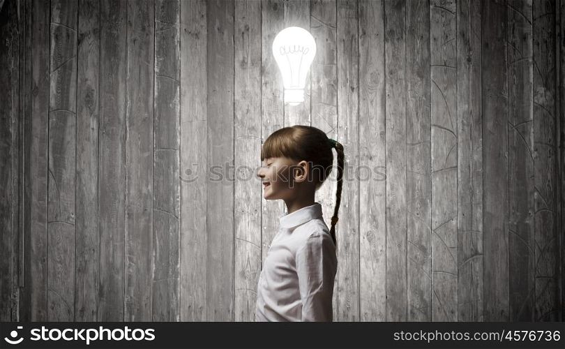 I have bright idea. Side view of girl of school age and light bulb above her head