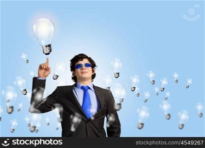 I have idea. Image of young businessman with light bulbs. New idea and inspiration