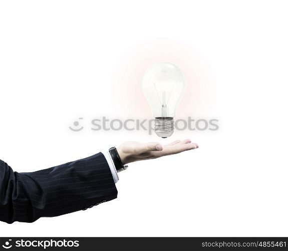 I have interesting idea. Businessman hand holding light bulb in palm